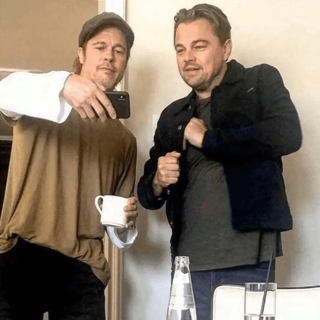 Brad Pitt showing Leo a meme