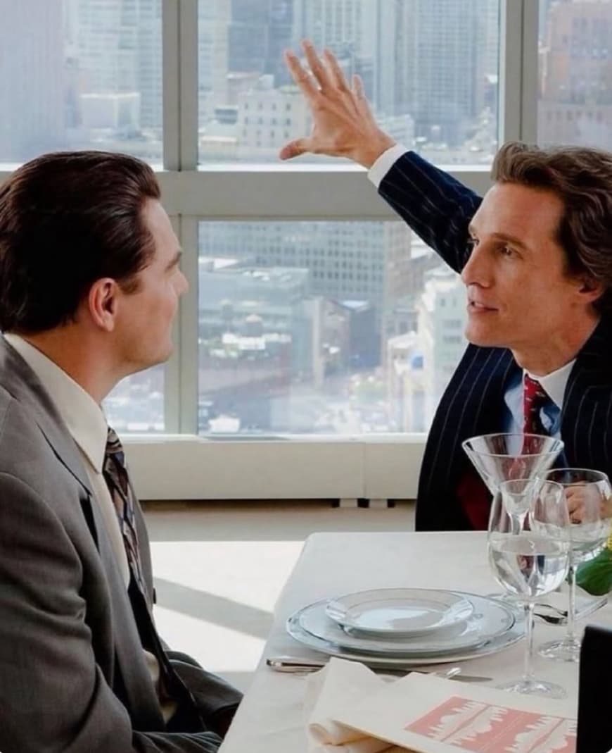 Matthew McConaughey explaining something to Leonardo DiCaprio