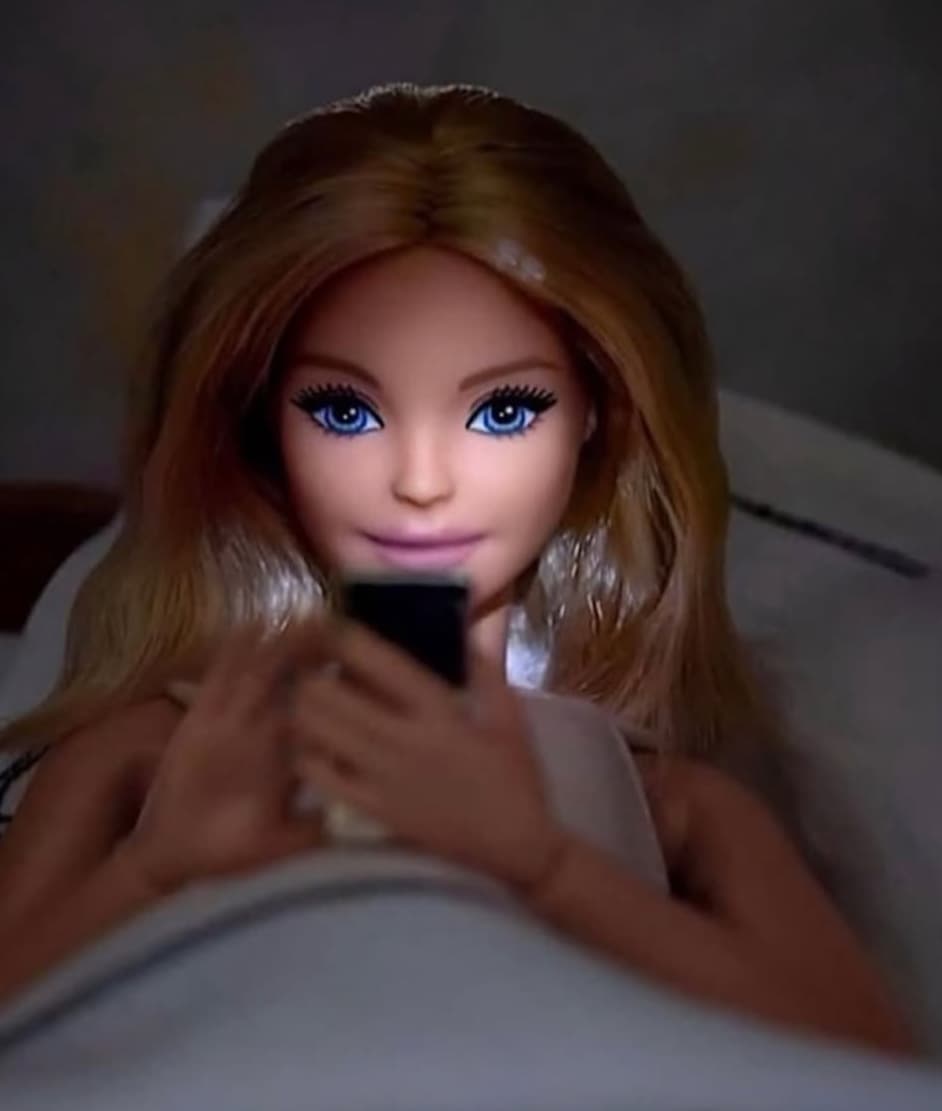 Barbie on phone in bed