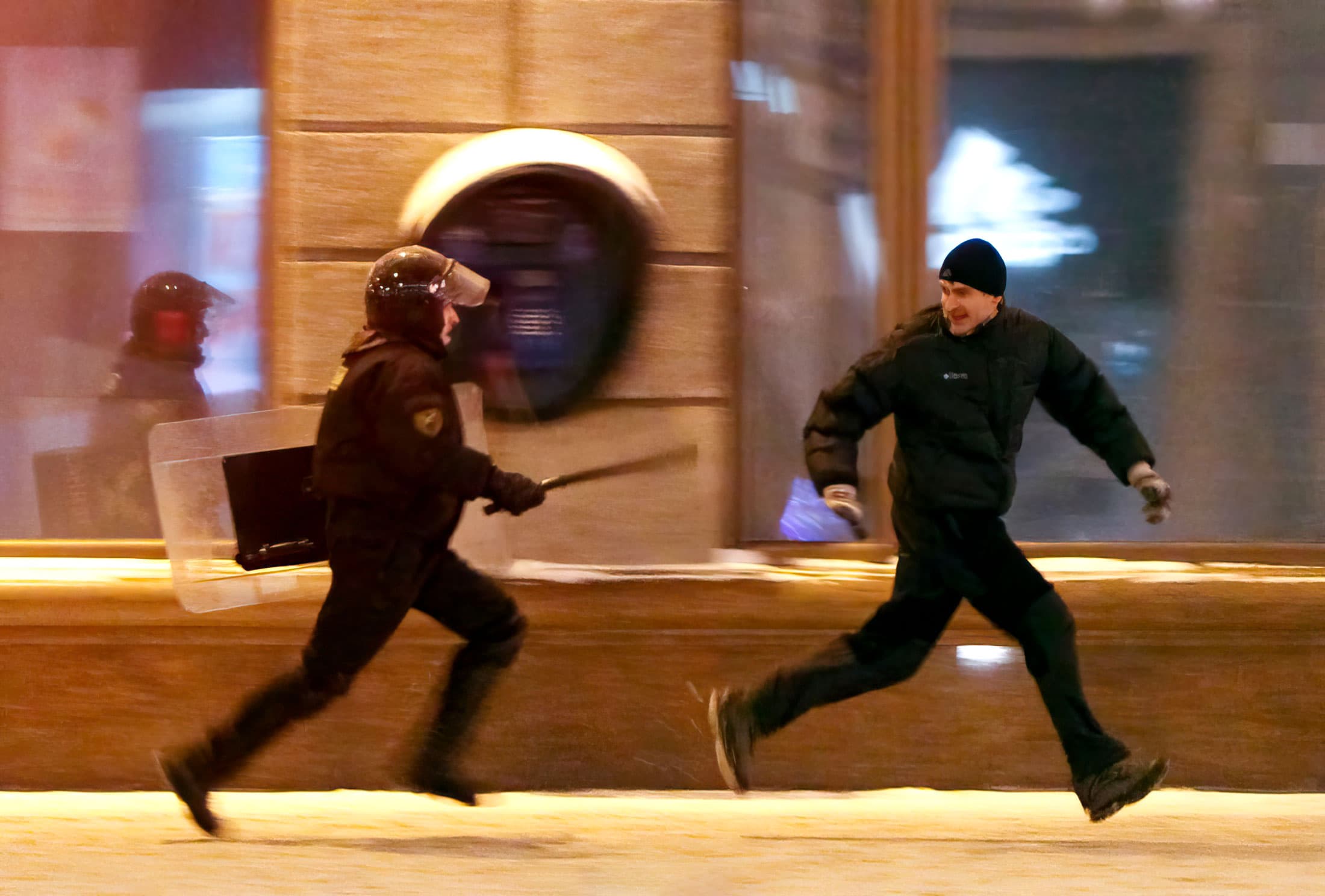 Cop chasing protestor