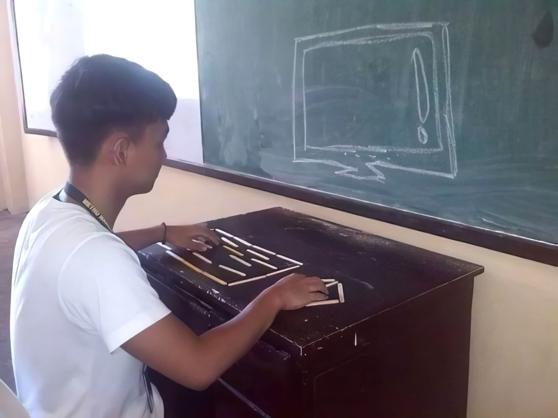 Drawing computer on chalkboard