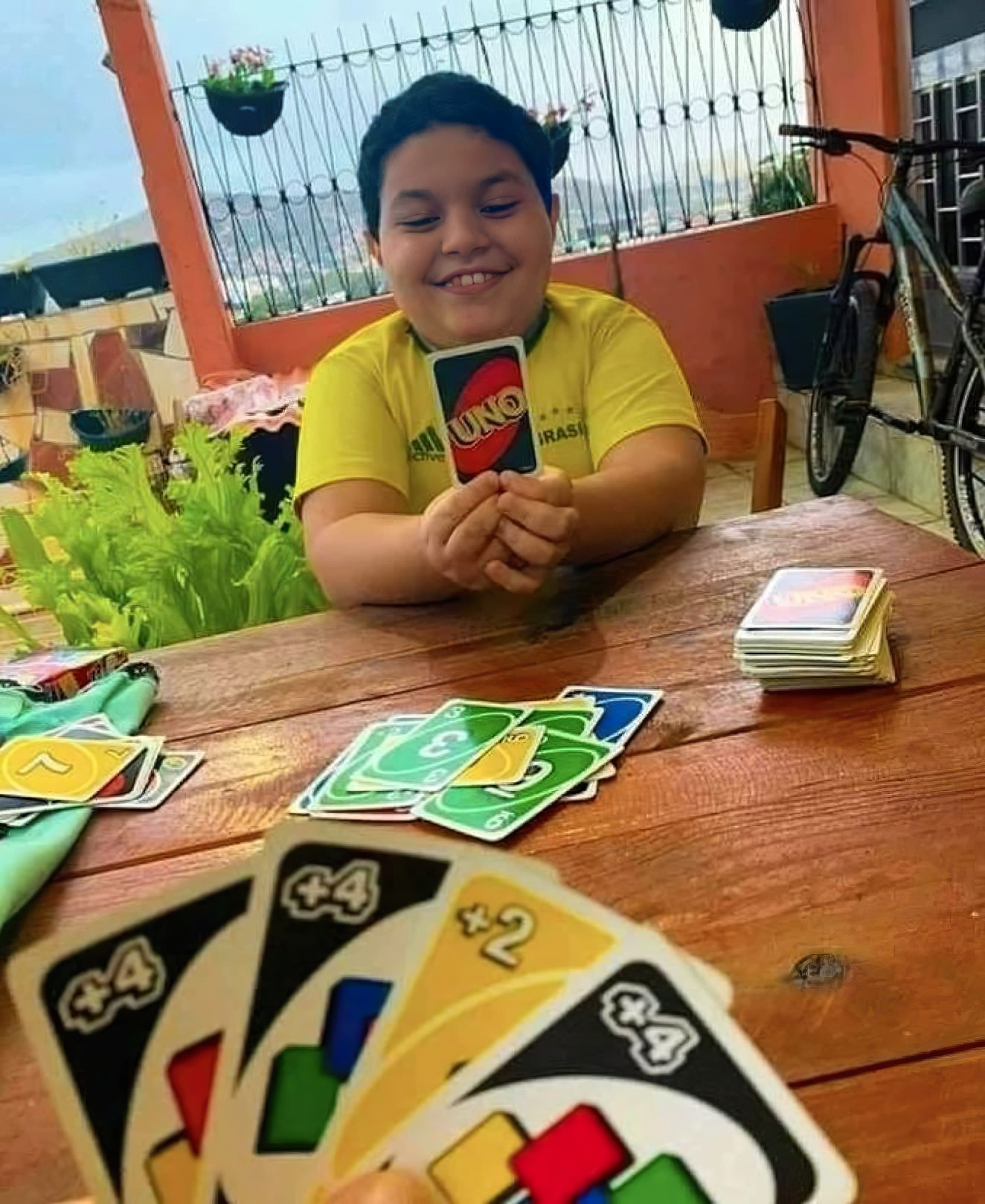 Kid holding Uno cards